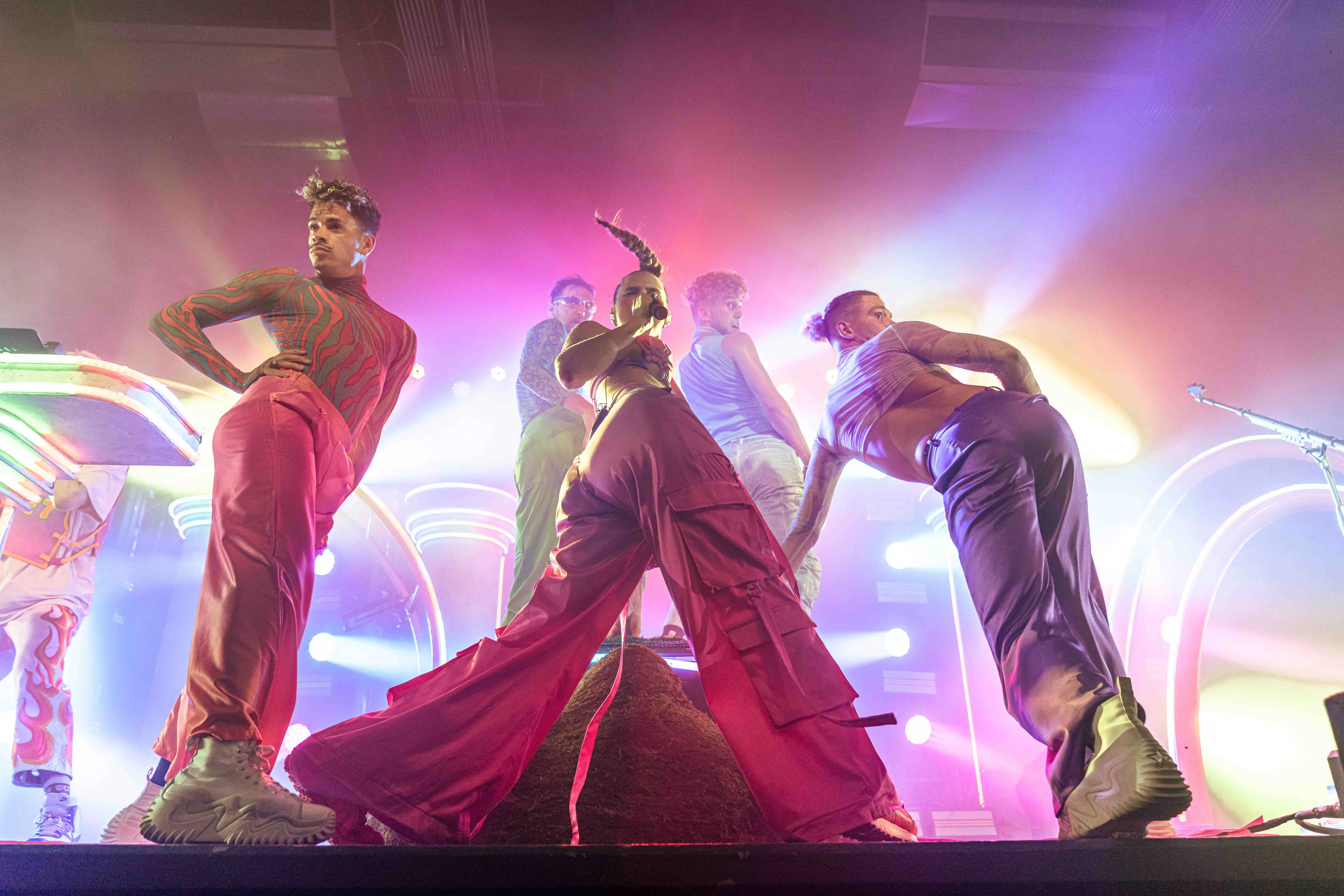 Sofi Tukker surrounded by Bob's Dance Shop dancers in front of the stage set.