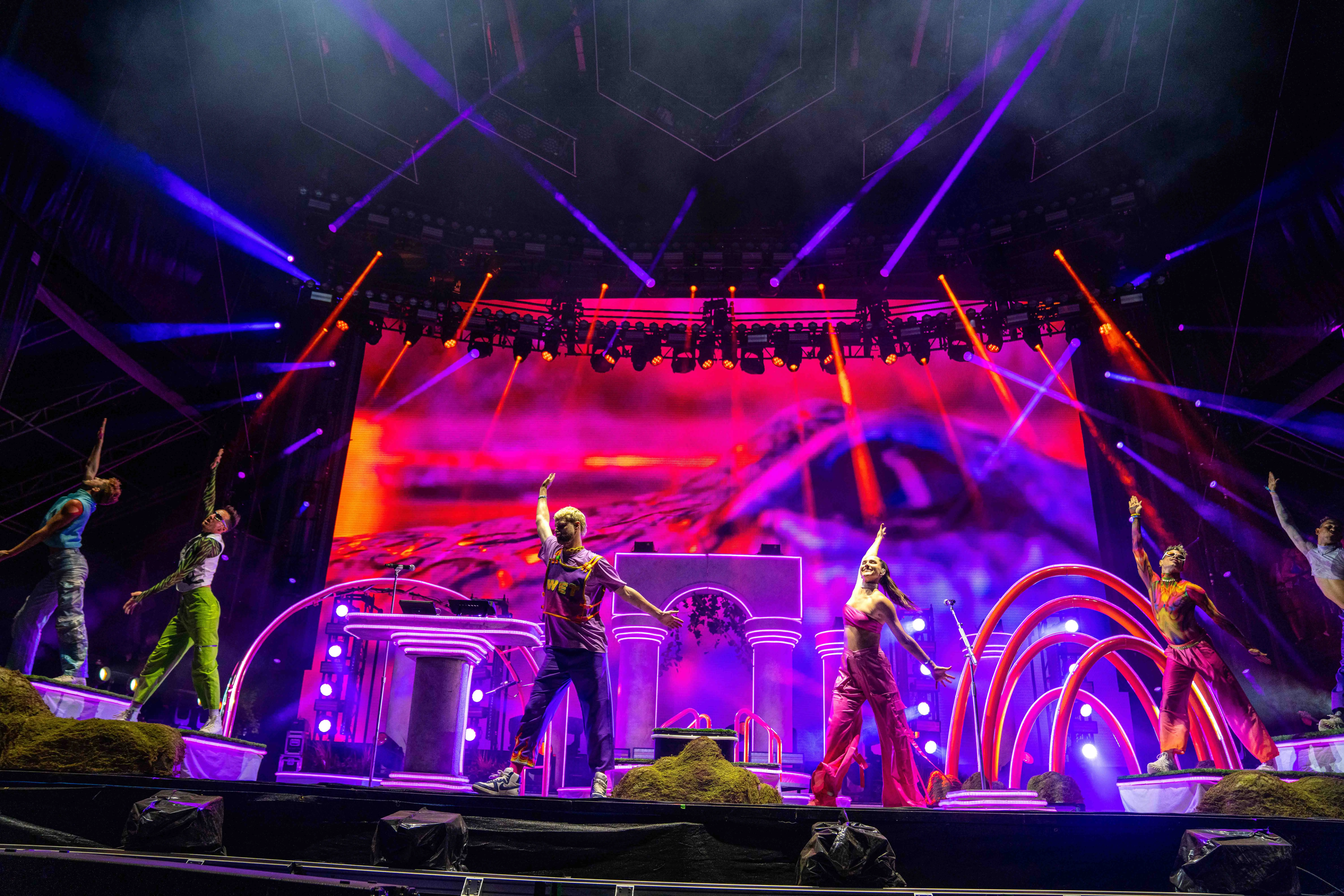 Sofi Tukker surrounded by Bob's Dance Shop dancers in front of the stage set.