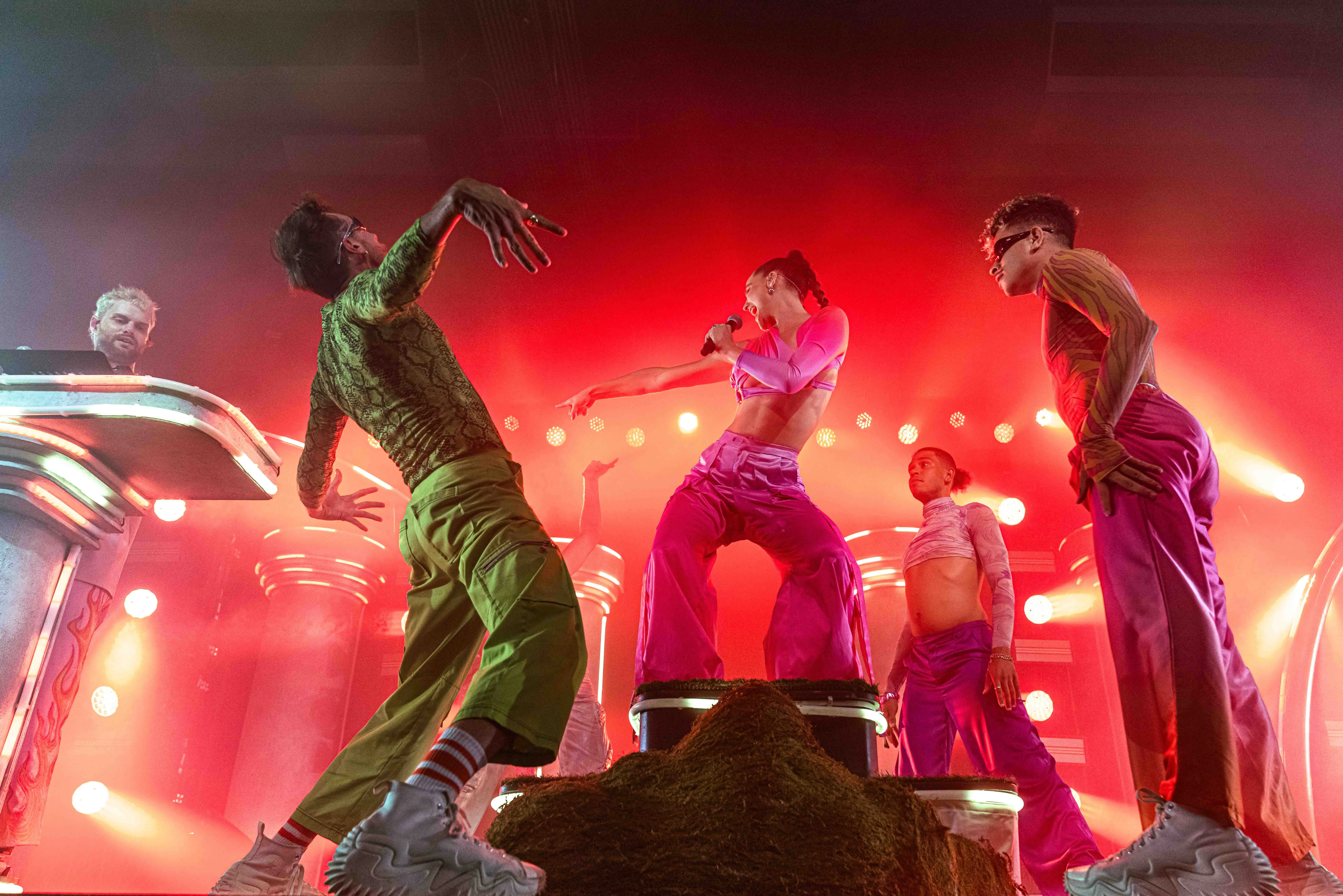 Sofi Tukker surrounded by Bob's Dance Shop dancers in front of the stage set.