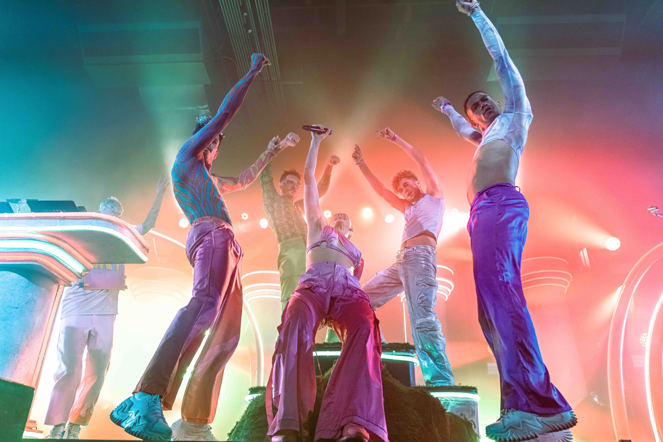 Sofi Tukker surrounded by Bob's Dance Shop dancers in front of the stage set.