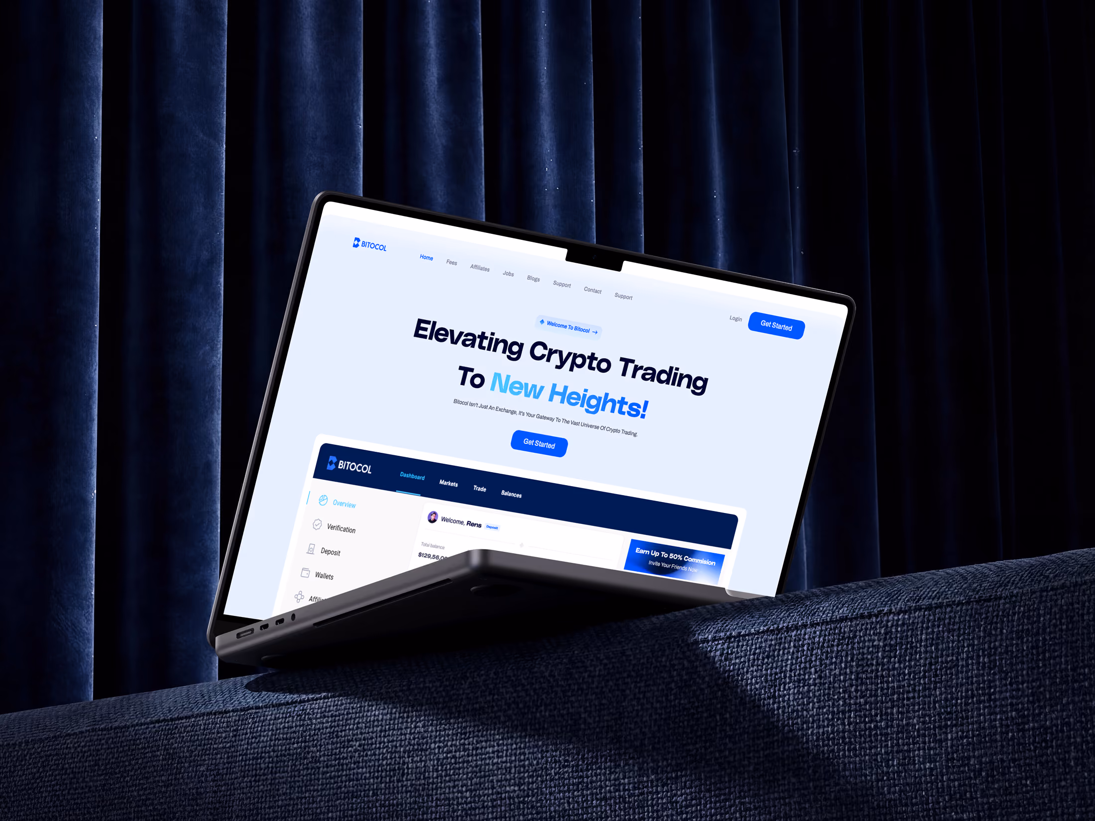 Laptop on navy fabric surface shows BITOCOL crypto trading site with 'Elevating Crypto Trading' headline.