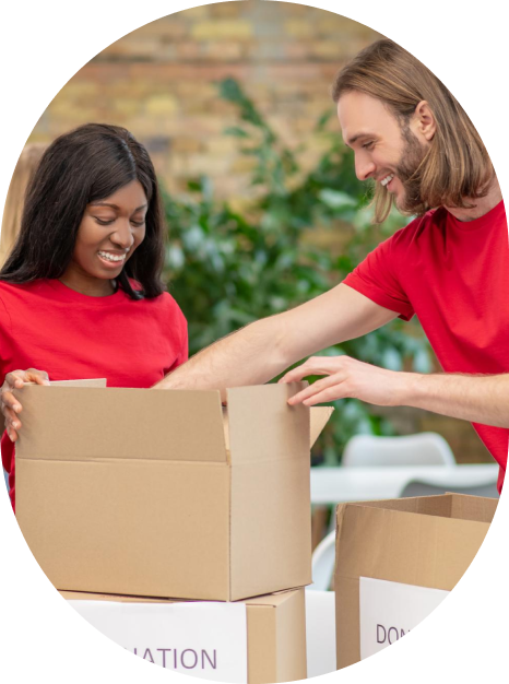 Man and woman unpacking moving boxes together inside a home, representing IMG Removals—a trusted relocation service based in Birmingham