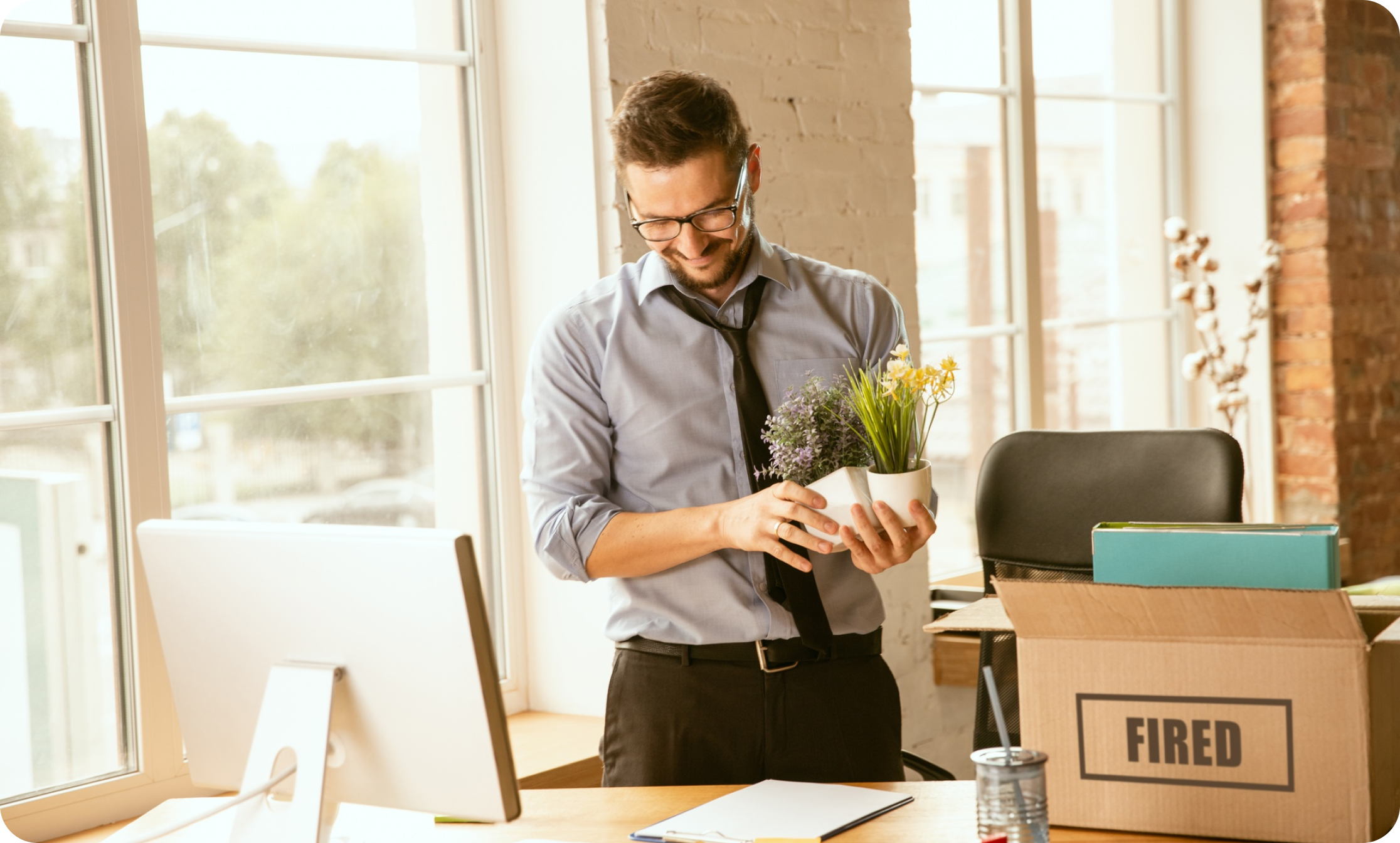 Man unpacking boxes inside a newly relocated office space after a move with IMG Removals in Birmingham—organising supplies, setting up his desk, and settling into the work environment.