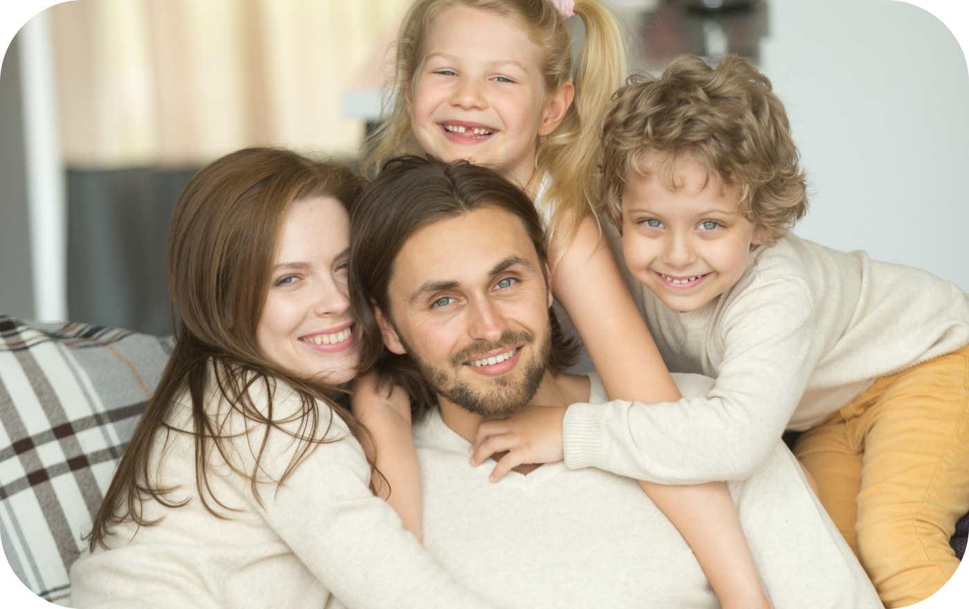 Happy family relaxing and smiling inside their new home after a successful relocation with IMG Removals in Birmingham—settled in, surrounded by unpacked boxes, and enjoying the comfort of a fresh start.