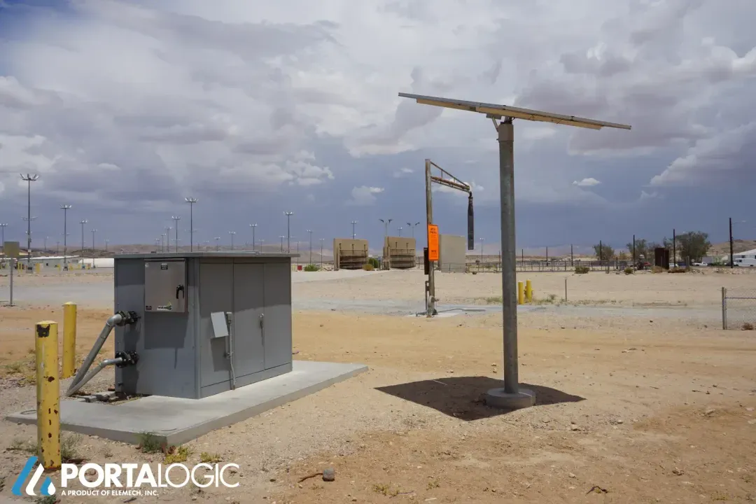 Solar powered bulk water filling station with overhead filling