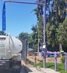 A commercial hauler fills its tank with reuse water