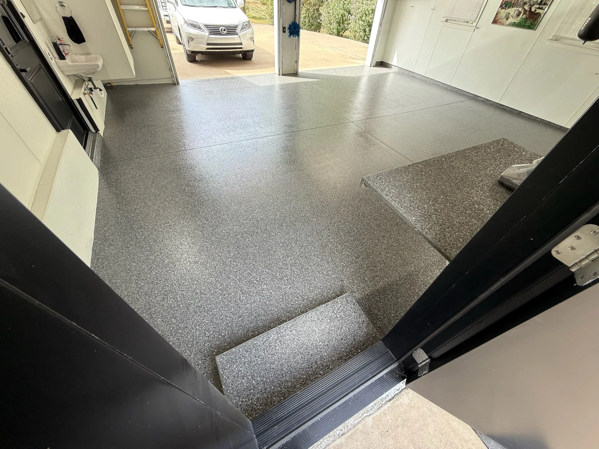 a garage floor with new polyaspartic floor coating