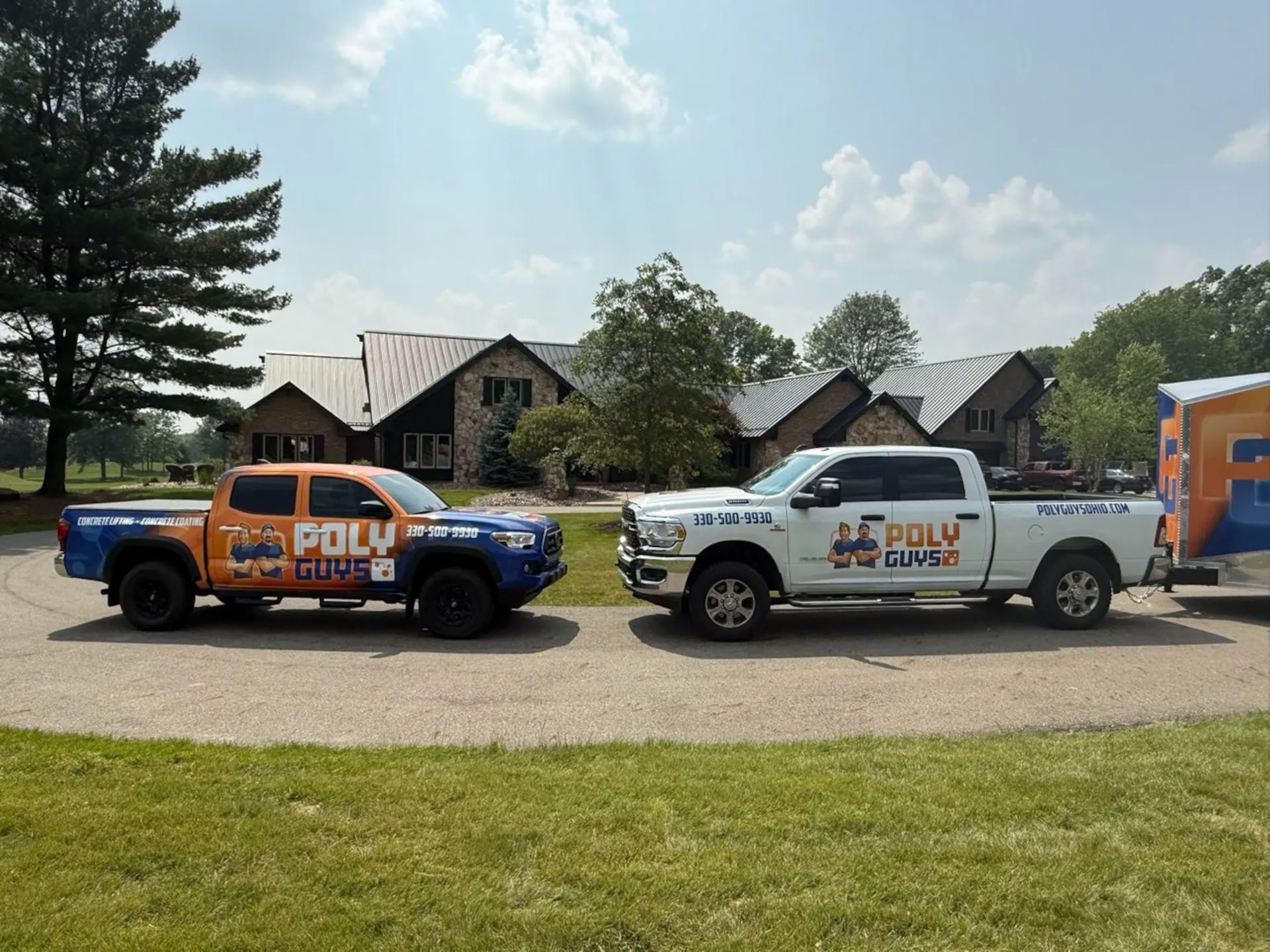 2 poly guys trucks facing each other in a residential driveway