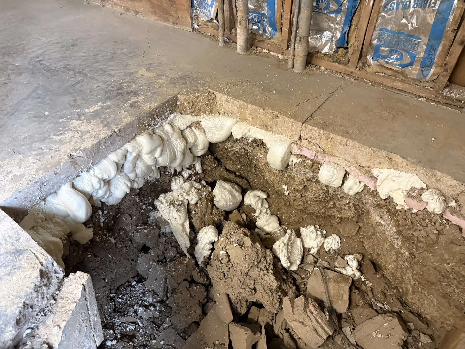 polyurethane lifting foam under a cut out concrete garage floor