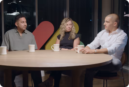 Sales leaders sitting around a table during a professional discussion