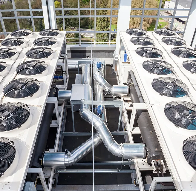 Ducting and large extractor fans on top of a building.