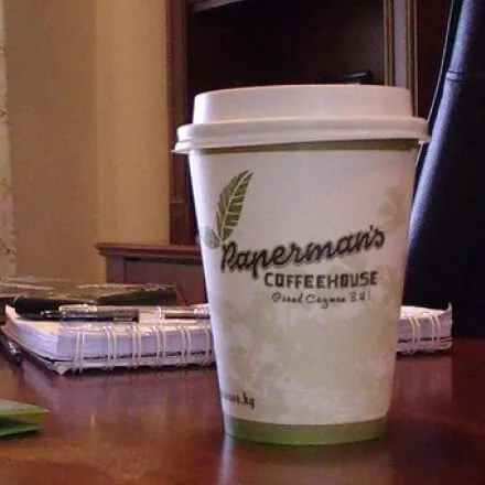 A retro Paperman's paper coffee cup, with our old logo on the side.