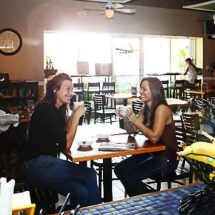 2 customers enjoying a coffee together in Paperman's Coffeehouse.