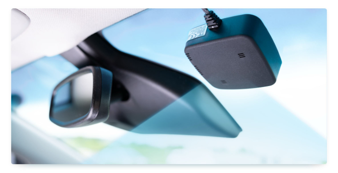 A   Bosch RideCare sensor is fixed to the windshield window of a car