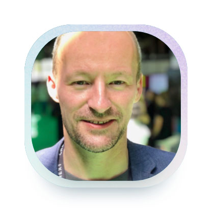 Imag of Rainer Becker, a middle-aged man and expert for autonomous driving, smiling in the camera