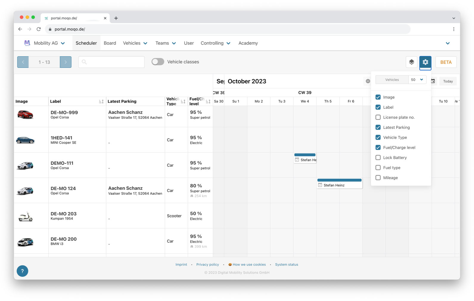 A screenshot of a scheduler view in a web application, displaying a weekly calendar for September and October 2023. The view lists several vehicles on the left, and the calendar shows scheduled bookings for some of them, assigned to a user named "Stefan Heinz."