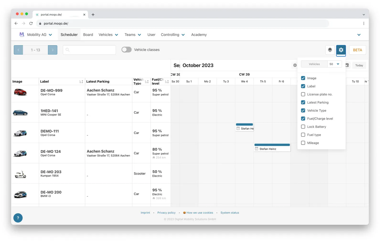 A screenshot of a scheduler view in a web application, displaying a weekly calendar for September and October 2023. The view lists several vehicles on the left, and the calendar shows scheduled bookings for some of them, assigned to a user named "Stefan Heinz."