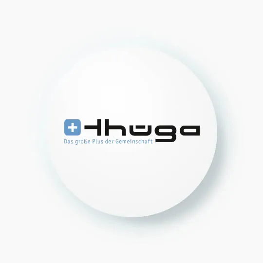 A white circle with a drop shadow features a black and blue logo. The logo, for a company called "Thüga," includes a blue square with a white cross and the text "Das große Plus der Gemeinschaft" (the big plus of cummunity) below it.