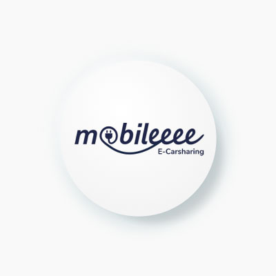 A simple, round icon with the logo for "mobileeee E-Carsharing." The logo features a charging plug integrated into the word "mobileeee."