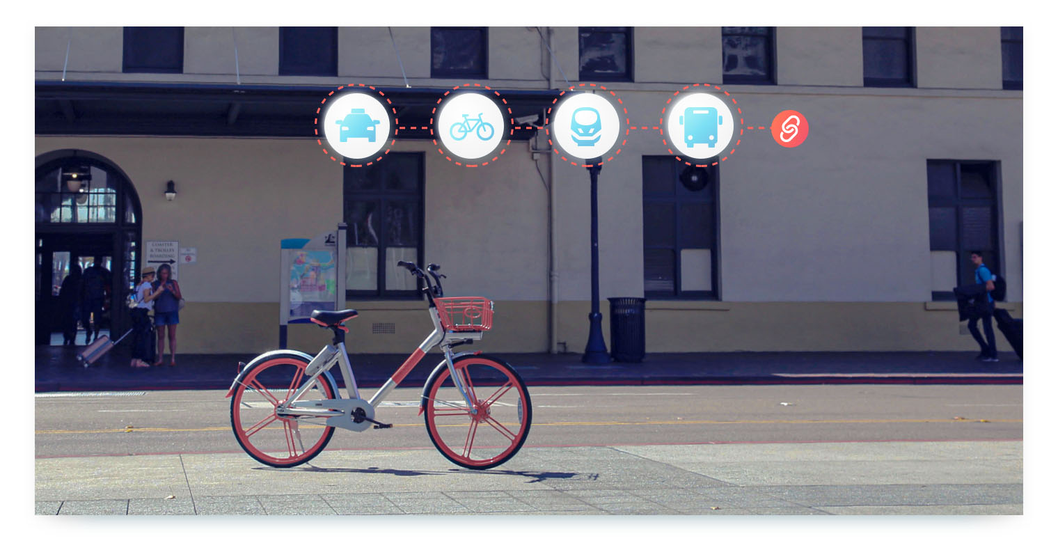 A shared mobility bike is parked on a city sidewalk in front of a public transit station. A chain of icons floats above the bike, representing a taxi, a bicycle, a train, and a bus, all connected by a chain link icon. This image visually explains how collaboration between different transportation modes is essential for creating an integrated shared mobility network.
