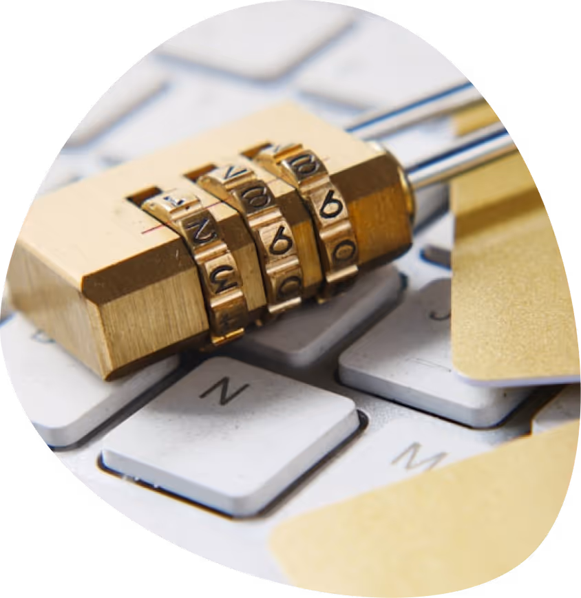 A golden padlock sitting on top of a computer keyboard.