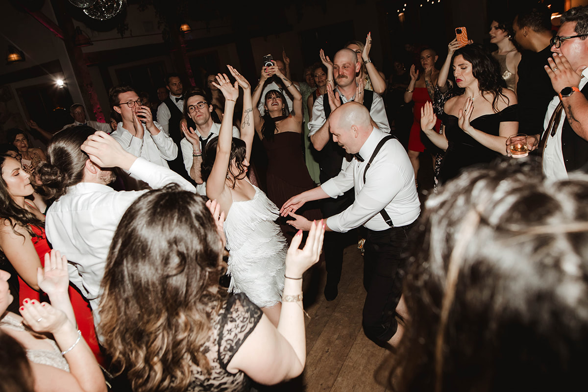 A wedding couple on their dance floor with all their guests. 