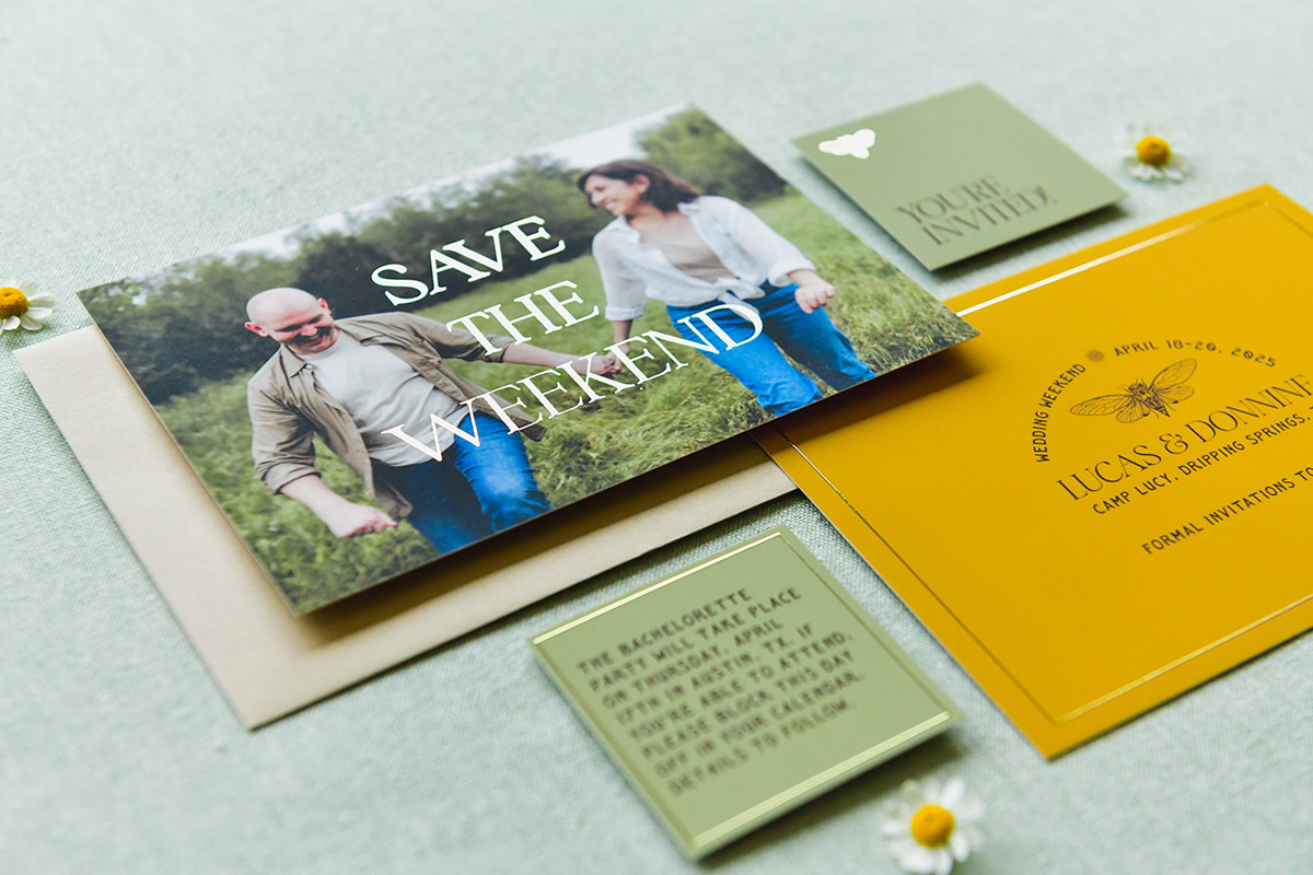 Gold leaf accents with "save the date" written on the front with a beautiful photo of the couple.