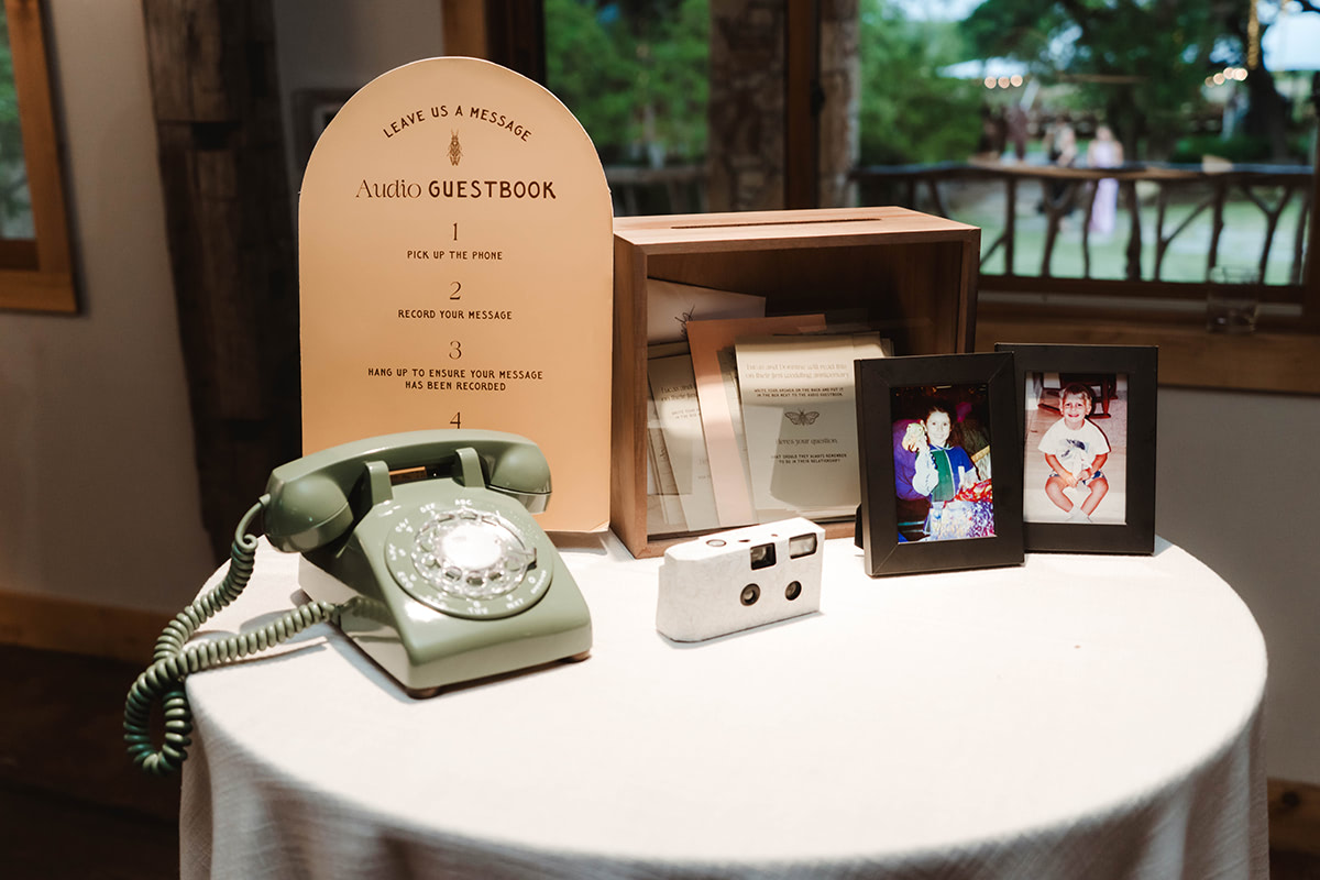 A vintage telephone with a sign that gives the instructions for people to leave a message as their guestbook contribution.
