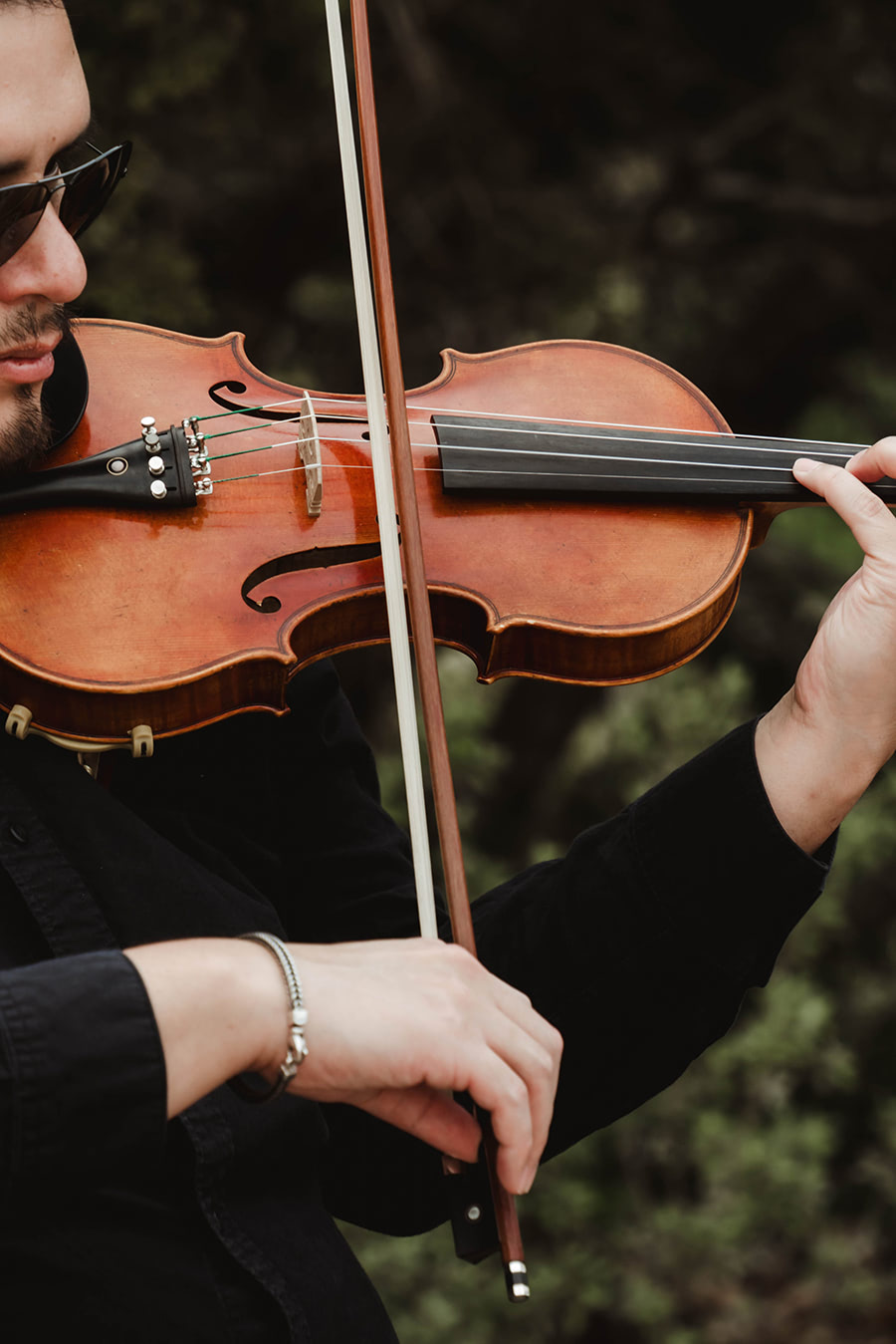A man playing a brown violin.
