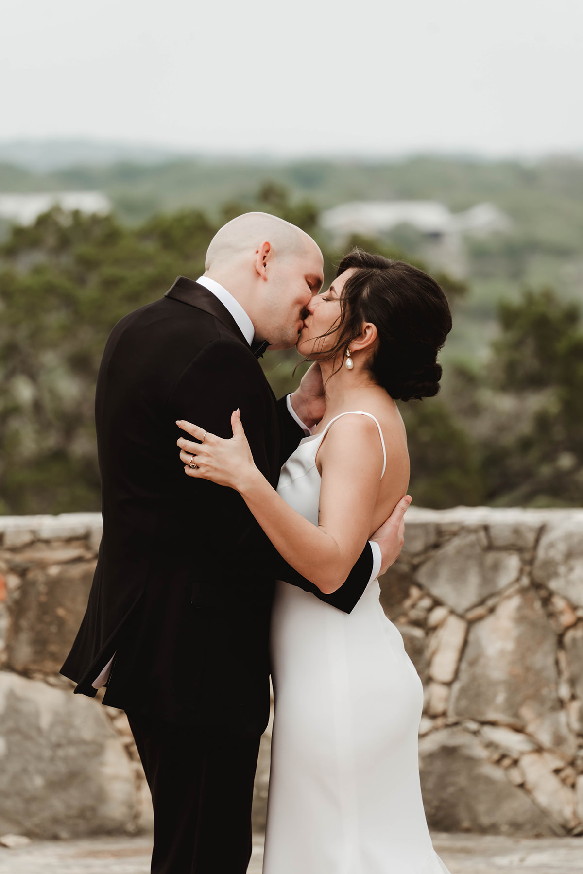A bride and groom in their wedding kiss.
