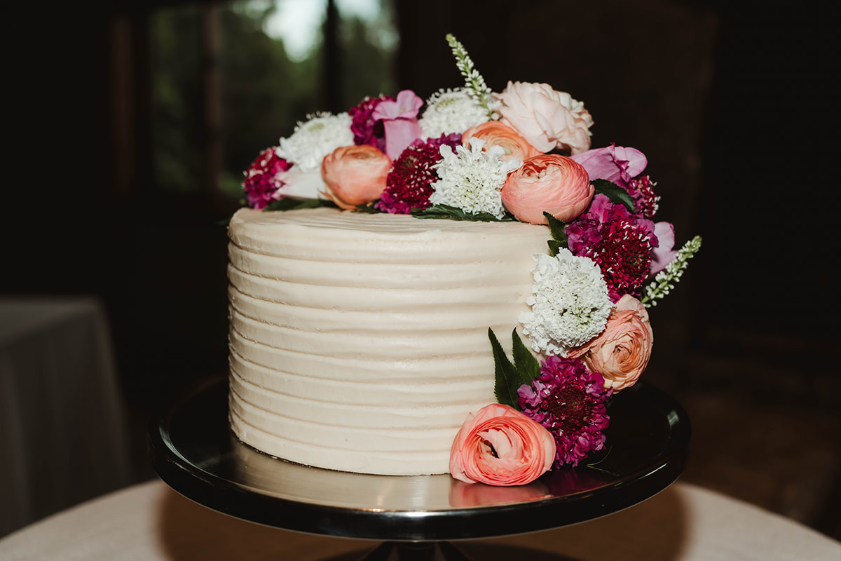 A floral display on a white wedding cake.