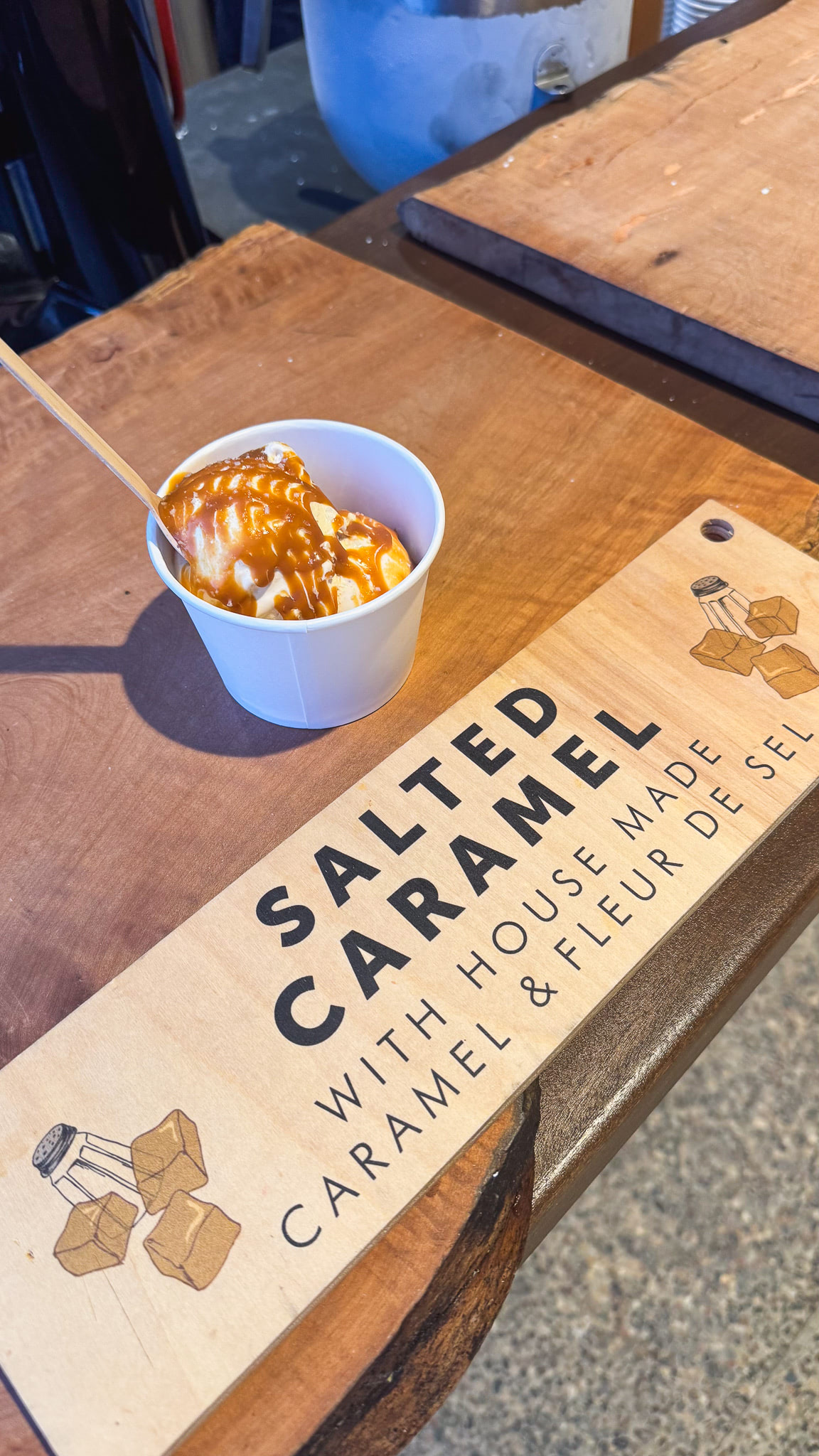 Ice cream topped with caramel drizzle on a bar 