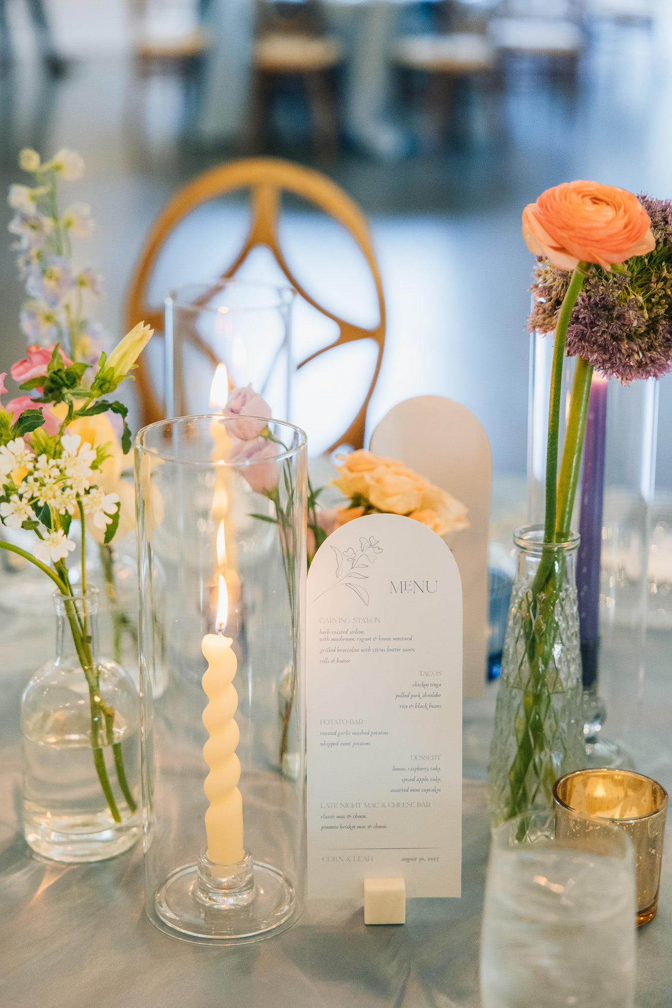 Food menu, candles, and florals on a table