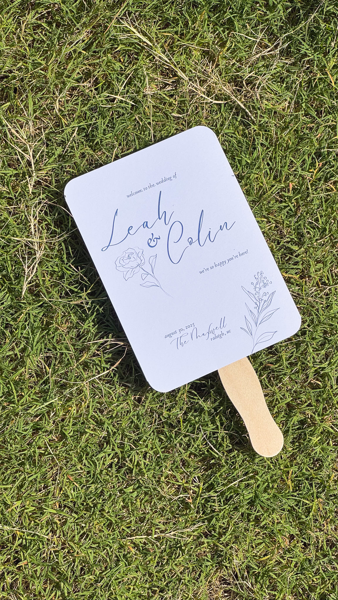 A fan lays on the grass