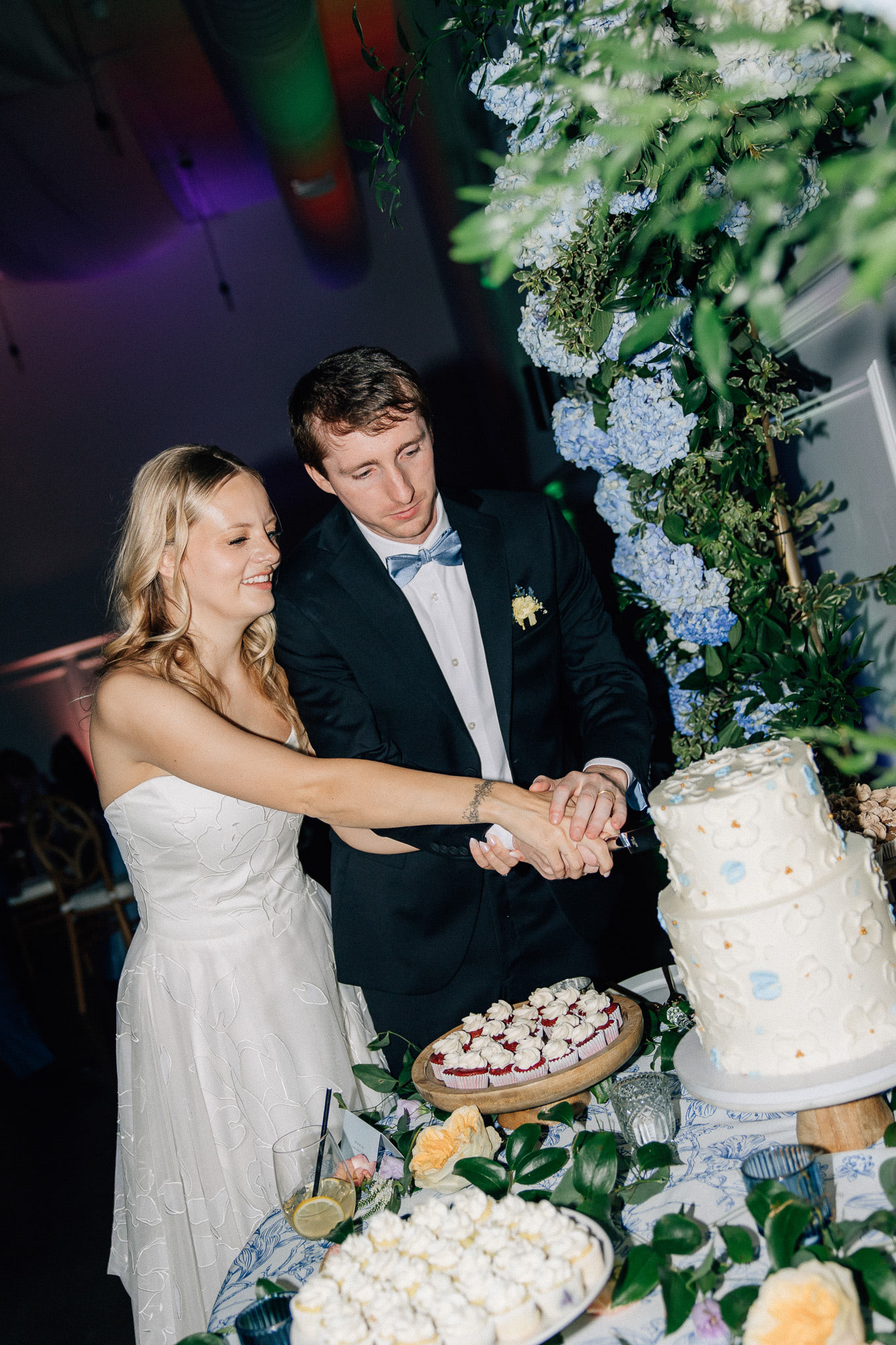 A bride and groom cutting their cake