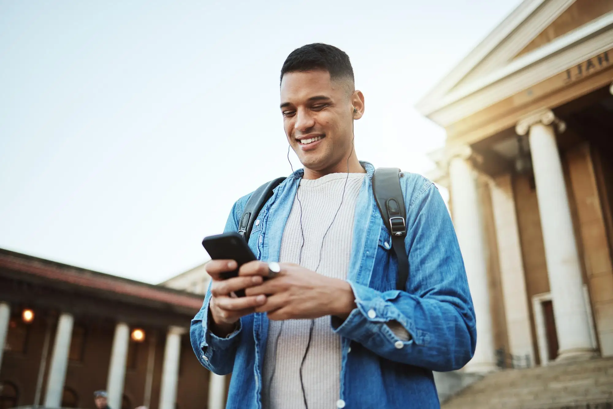 Young man smiling at his phone