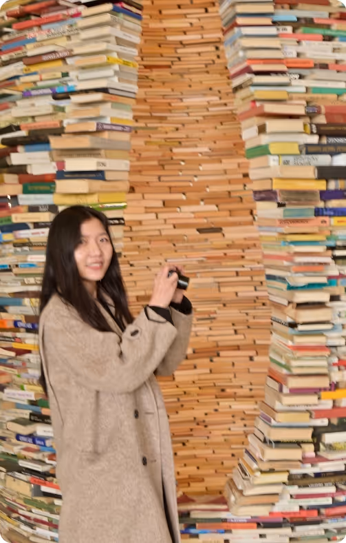 Ying Qi smiling next to book tunnel