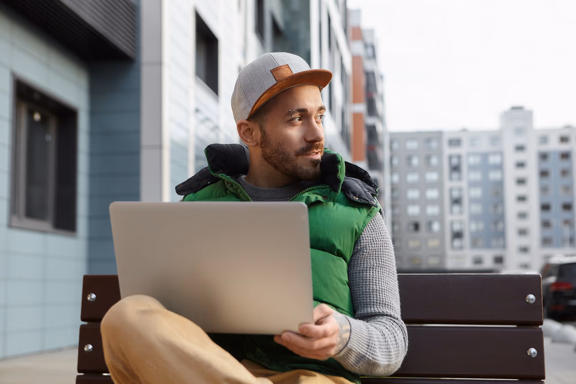 Young man working on his laptop outdoors
