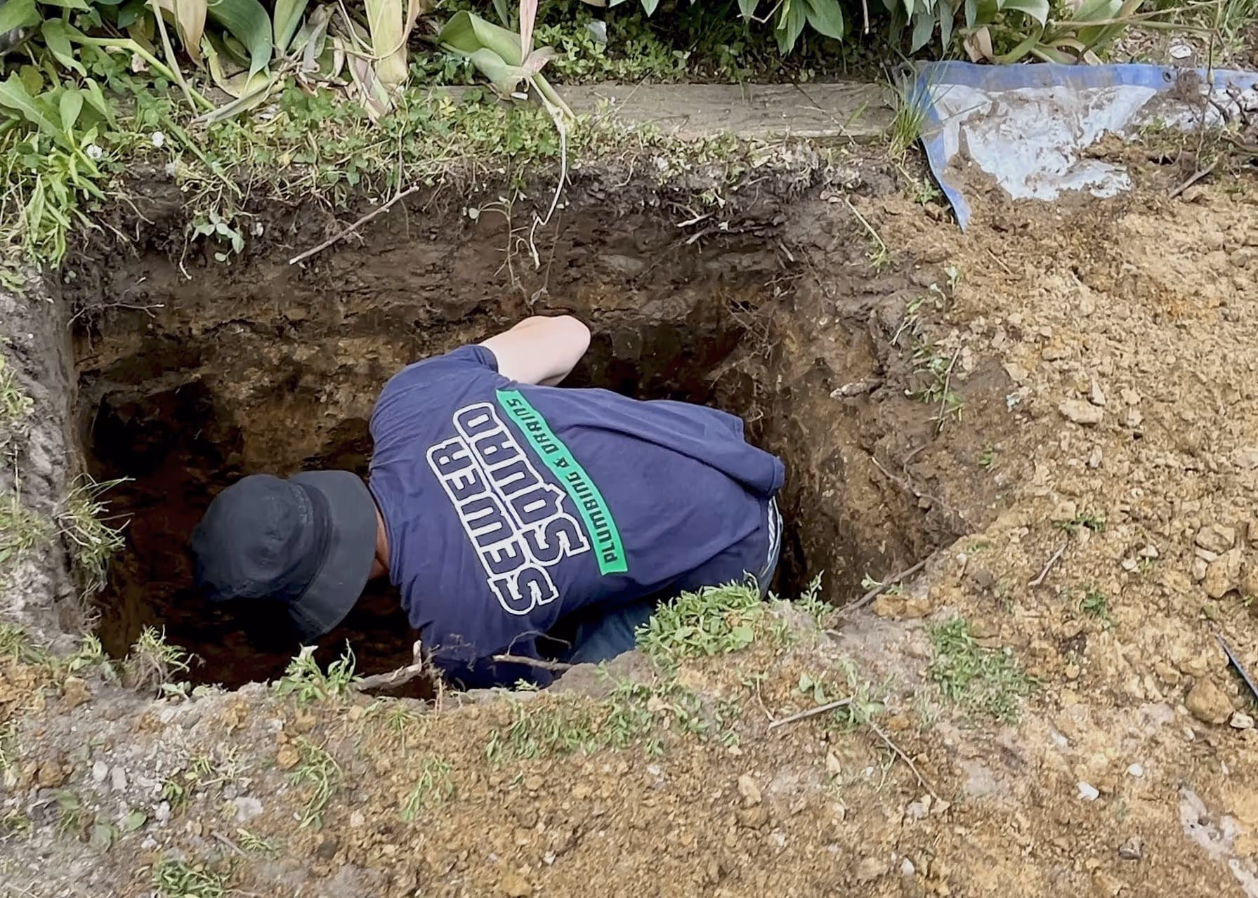 a guy in a hole on the ground working