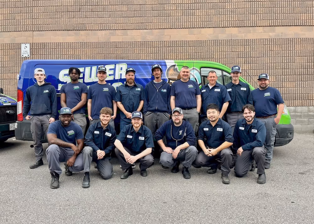 Sewer Squad Team members in front of the van