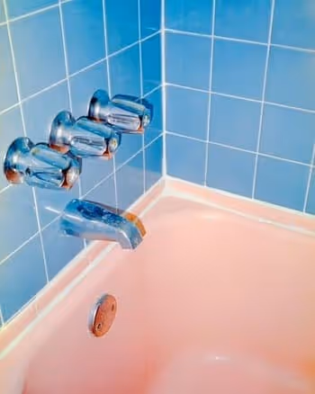 pink bathtub and blue tiled wall