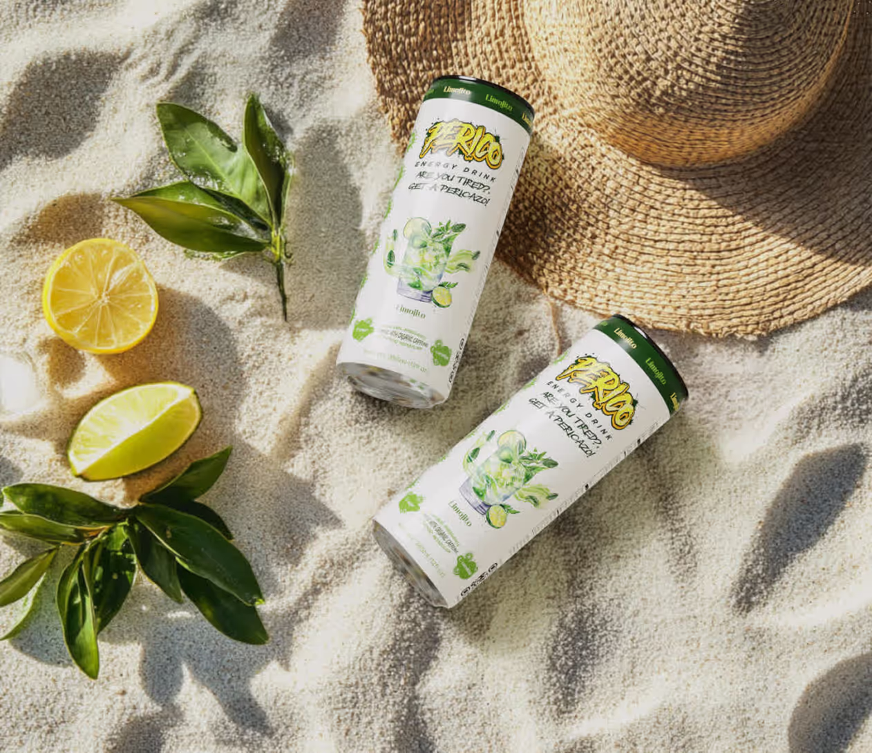 Perico Limojito energy drink cans on a sunny beach with lemon, lime, and mint, promoting a refreshing travel-ready boost with organic caffeine and zero sugar.