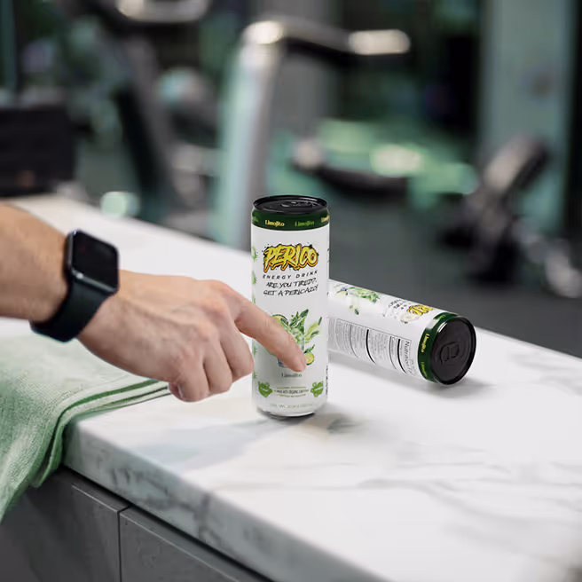 Close-up of a Limojito Perico Energy Drink can in a gym setting, emphasizing its clean energy boost for pre-workout or post-workout recovery, made with organic caffeine and essential amino acids to support metabolism and hydration. 