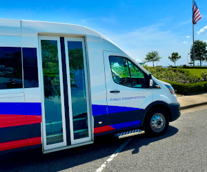 ALTRANS van parked near american flag and sunny coastal day