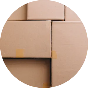Four cardboard boxes arranged close together on a flat surface, viewed from above, with light brown tape sealing some edges.