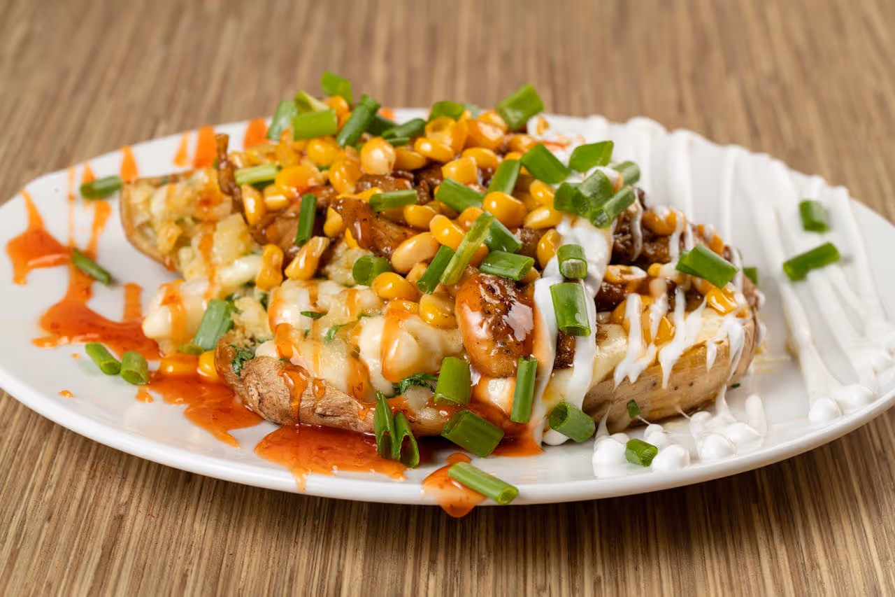 A plate of food with a white plate and a brown table.
