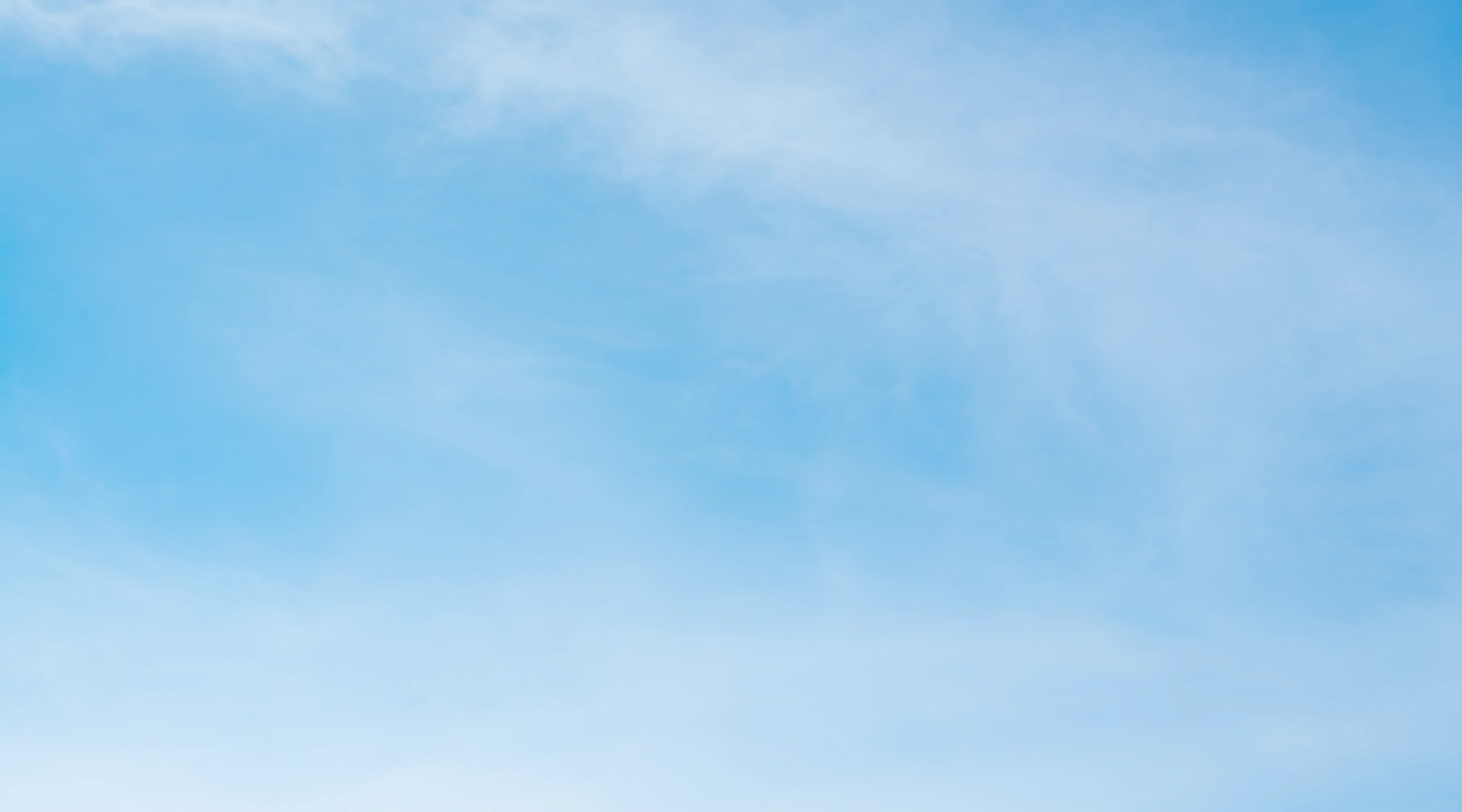 Bright blue sky with scattered light white clouds.