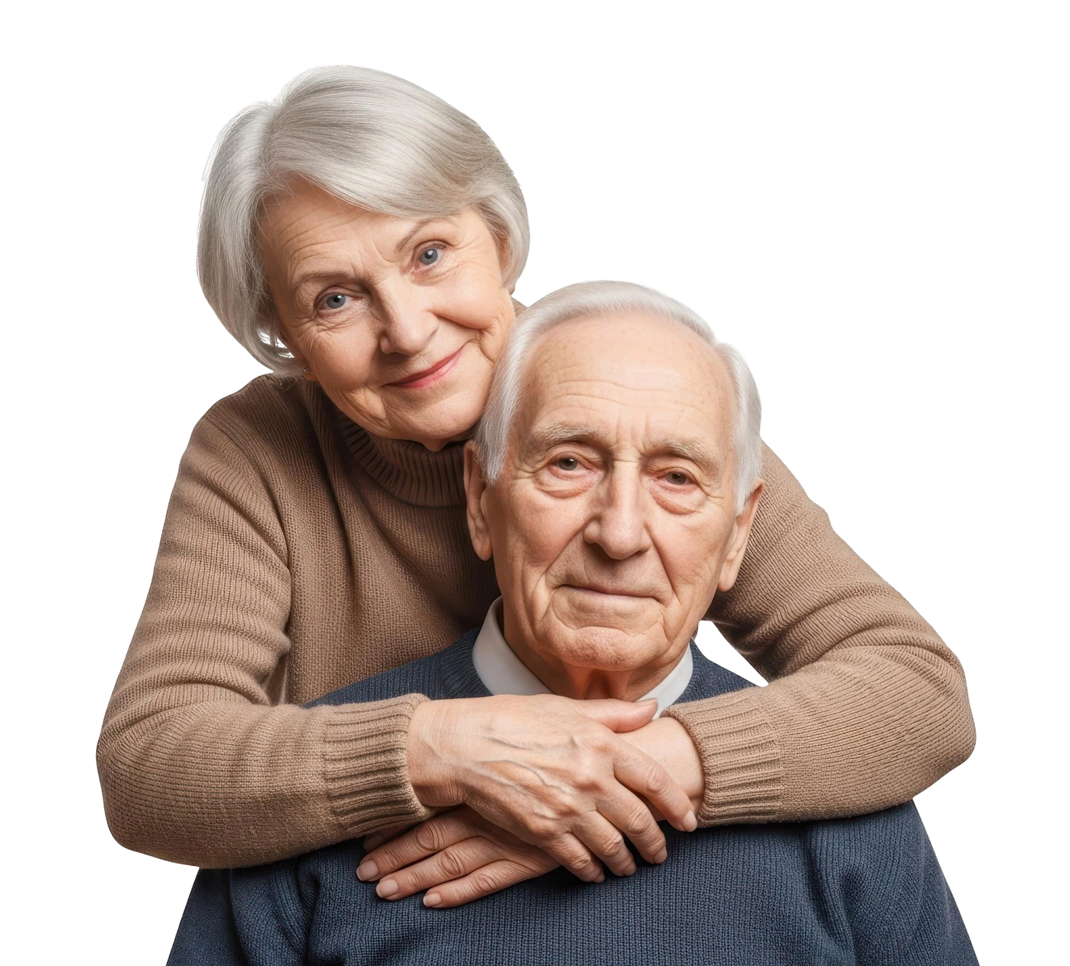 Smiling elderly woman embracing elderly man from behind against a black background.