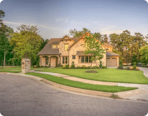 House front with trees surrounding
