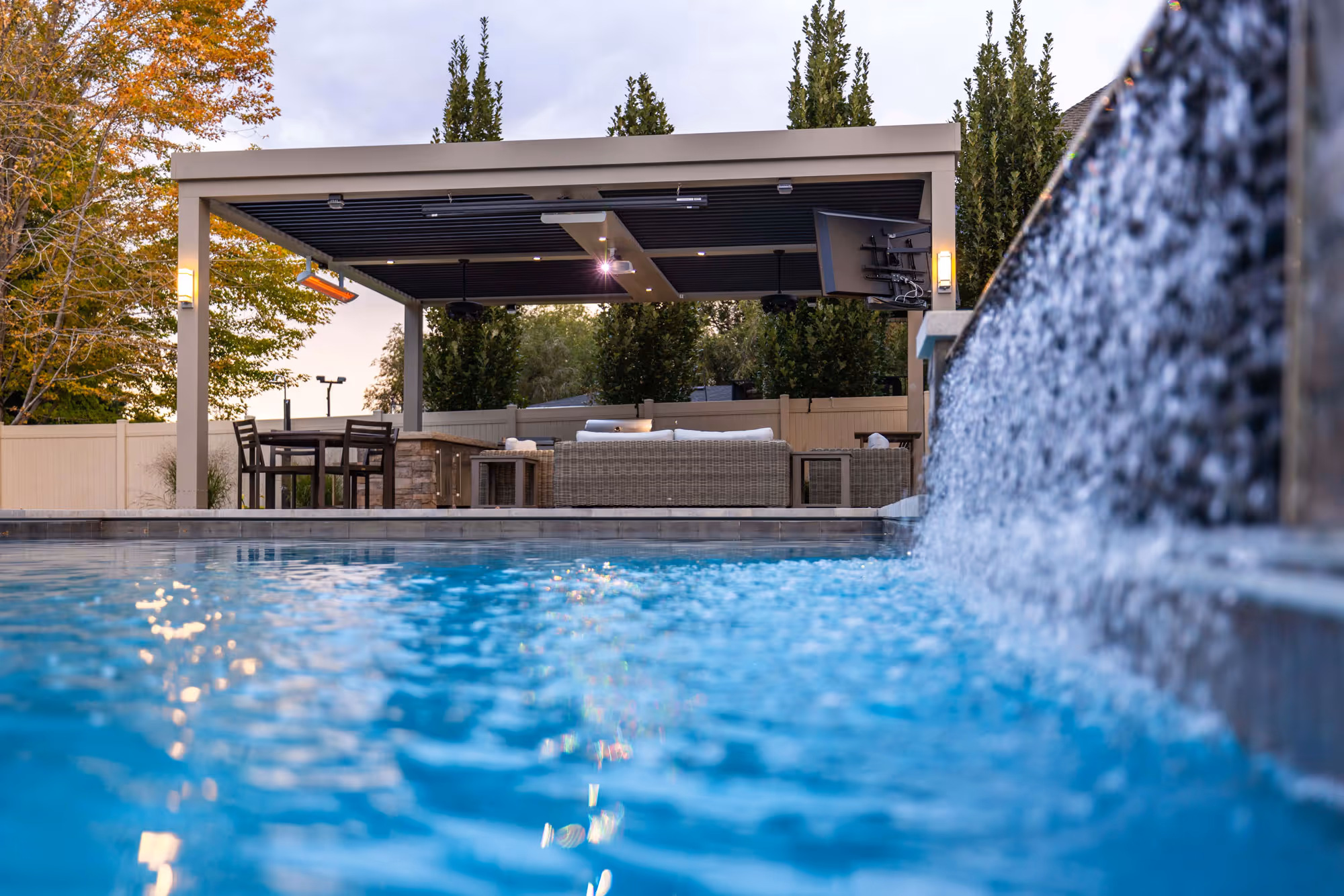 A motorized louvered roof in a Salt Lake City yard with a swimming pool.